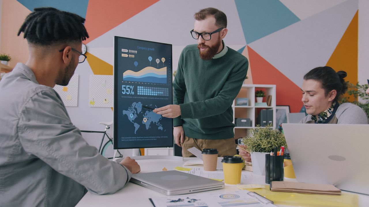 Crafting Captivating Headlines: Your awesome post title goes here Team collaboration on business growth strategy with data charts in a modern office.