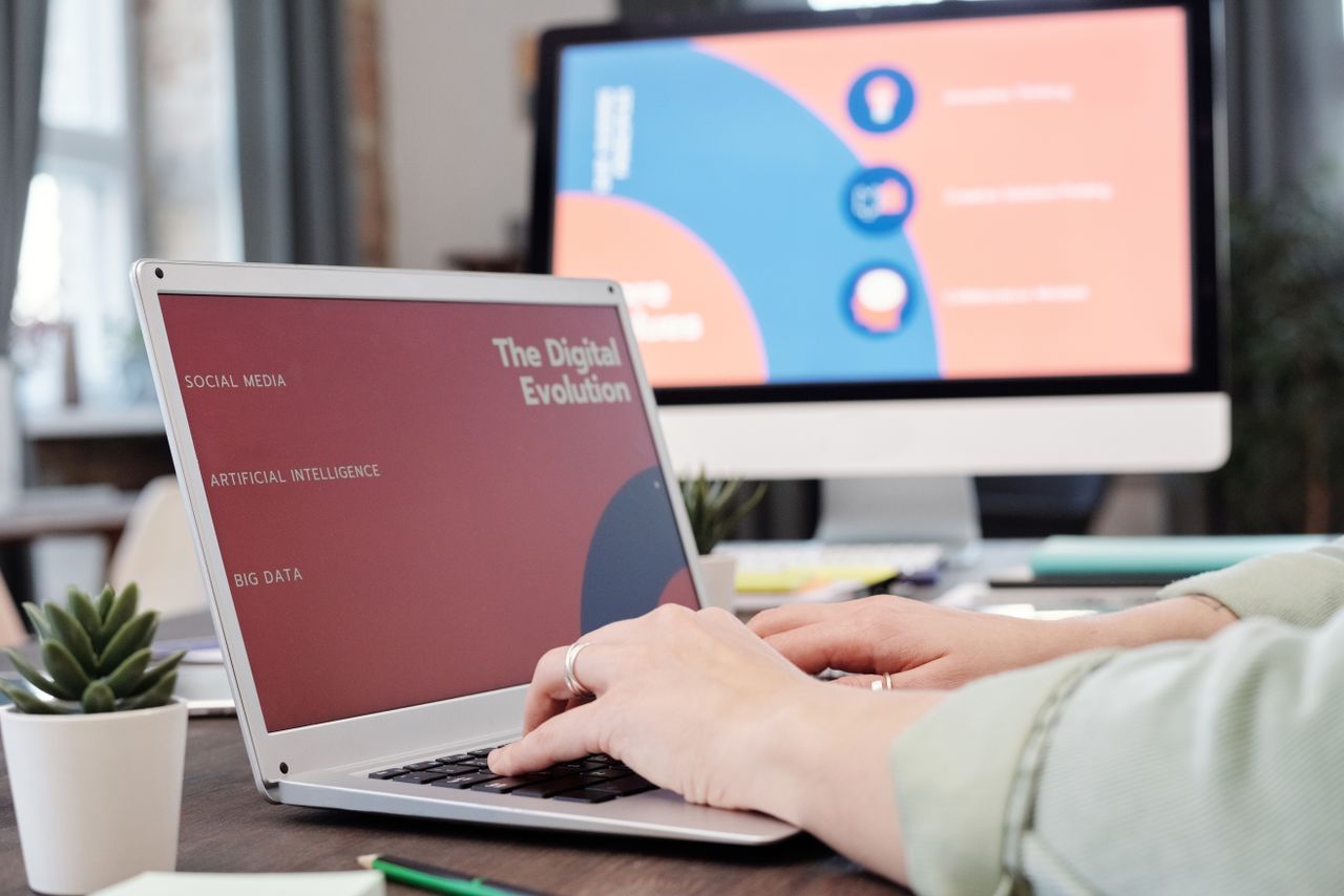 the-story Laptop user typing with digital evolution concept on screen in a modern office environment.